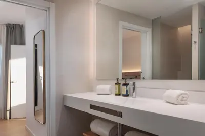 a bedroom with a bed and a large glass window at Tembo Barcelona in Barcelona