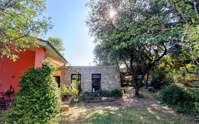 a home with a red house and trees at Casa de invitados in La Torre de Claramunt
