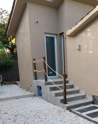 a set of stairs leading to a door of a house at Cerca de Barcelona, y entre tres Parques Naturales, casa de 4 habitaciones y 2 baños con piscina, barbacoa y chimenea in San Antonio de Vilamajor