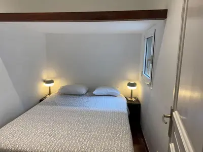 a bedroom with a bed with two pillows on it at Ático con encanto, centro, con aparcamiento in Barcelona