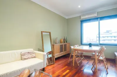 a living room with a couch and a table at Ático con encanto, centro, con aparcamiento in Barcelona