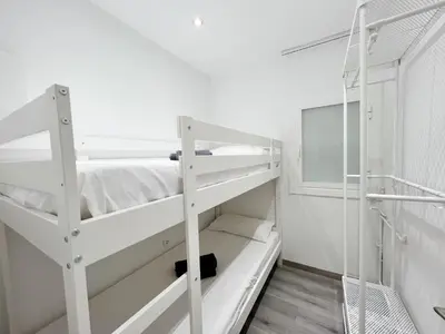 a room with two bunk beds and a window at Cosy Montroig Sitges in Sitges