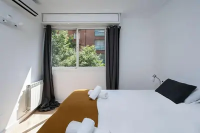 a bedroom with a bed and a window at Canela Homes BARCELONA PADILLA in Barcelona