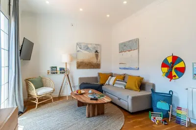 a living room with a couch and a table at Canela Homes BARCELONA FIRA in Barcelona