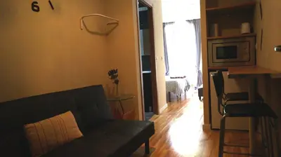 a living room with a couch and a table at Good-Home Paseo de Gracia in Barcelona