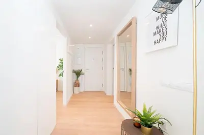 a hallway of a home with a mirror and plants at Soler Apartments in Sant Adria de Besos