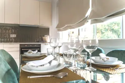 a table with wine glasses and plates on it at Soler Apartments in Sant Adria de Besos