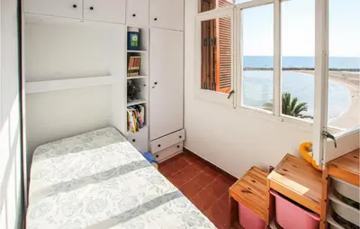 a bedroom with a bed and a view of the ocean at 4 Bedroom Lovely Apartment In Cunit in Cunit
