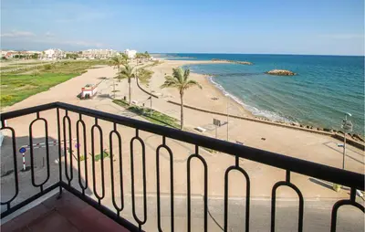 a balcony with a view of a beach and the ocean at 4 Bedroom Lovely Apartment In Cunit in Cunit