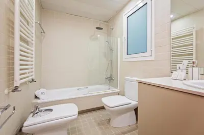 a bathroom with a toilet and a tub and a sink at Plaza Catalunya in Barcelona