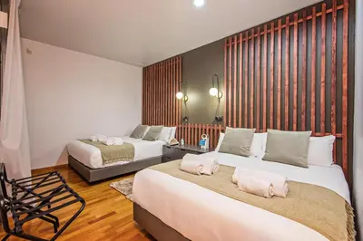 a bedroom with two beds with pink pillows on them at Plaza Catalunya in Barcelona