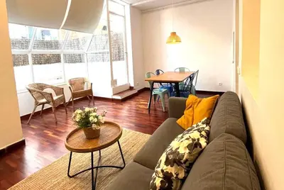 a living room with a couch and a table at FANTASTIC apartment in Barcelona in Barcelona