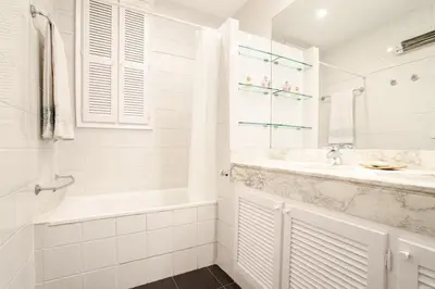 a white bathroom with a tub and a sink at FANTASTIC apartment in Barcelona in Barcelona