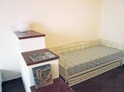 a room with two beds and a table with a magazine at FANTASTIC apartment in Barcelona in Barcelona