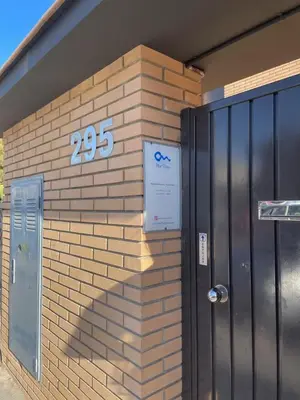 a brick building with a sign on the side of it at MarPlana in Castelldefels