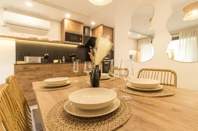 a kitchen and dining room with a table and chairs at MarPlana in Castelldefels
