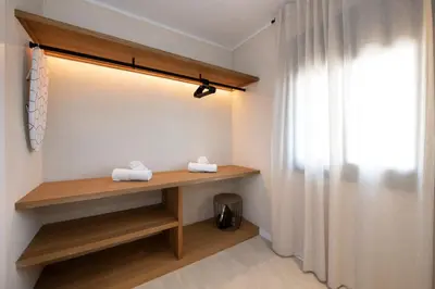 a room with a wooden shelf and a window at MarPlana in Castelldefels