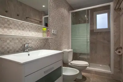 a bathroom with a sink and a toilet and a shower at Stay U-nique Apartments Marina III in Barcelona