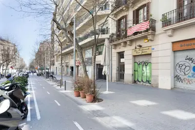 a city street with a motorcycle parked next to a building at Stay U-nique Apartments Granados in Barcelona