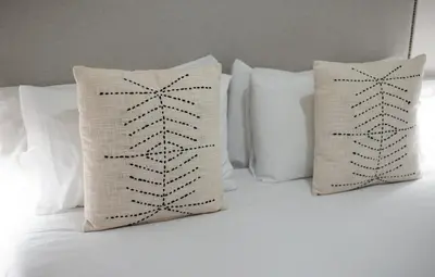 two pillows on a bed with white pillows at Stay U-nique Apartments Granados in Barcelona