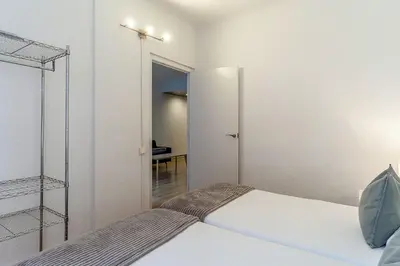 a small bedroom with a bed and a mirror at 1690 - AB Eixample Rosselló in Barcelona