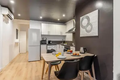 a small kitchen with a table and chairs in a room at 1690 - AB Eixample Rosselló in Barcelona