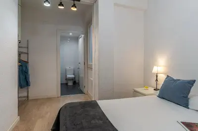a bedroom with a bed and a bathroom with a toilet at 1690 - AB Eixample Rosselló in Barcelona