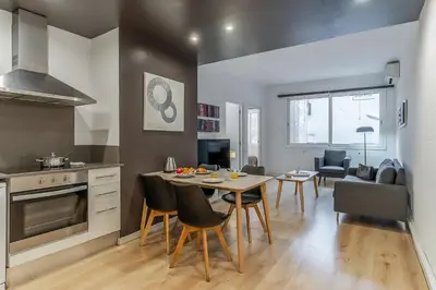 a kitchen and living room with a table and chairs at 1690 - AB Eixample Rosselló in Barcelona