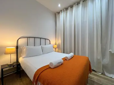 a bedroom with a bed with two towels on it at Stay U-nique Apartments Caminal in Barcelona