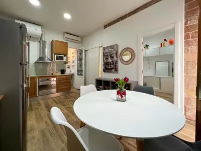 a kitchen and dining room with a white table and chairs at Stay U-nique Apartments Caminal in Barcelona