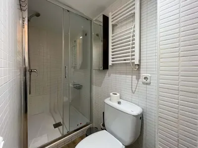 a bathroom with a toilet and a glass shower at Stay U-nique Apartments Caminal in Barcelona