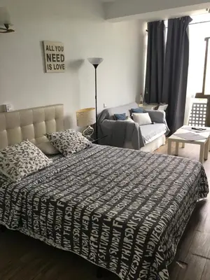 a bedroom with a bed and a couch at Beach Castelldefels in Castelldefels