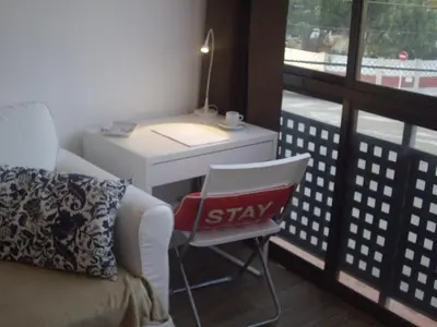 a room with a desk and a chair next to a window at Beach Castelldefels in Castelldefels