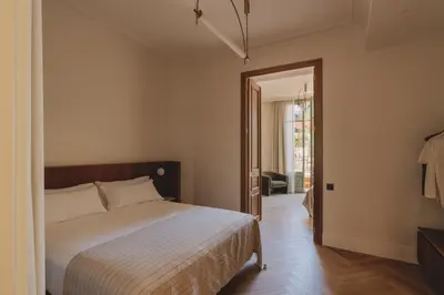 a bedroom with a bed and a door to a hallway at Casa Llimona Hotel Boutique in Barcelona