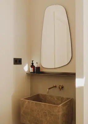a bathroom with a stone sink and a mirror at Casa Llimona Hotel Boutique in Barcelona