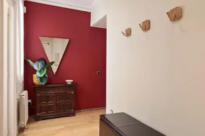 a room with a red wall and a mirror at Enjoy Apartments Donna in Barcelona