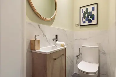 a bathroom with a toilet and a sink and a mirror at Enjoy Apartments Donna in Barcelona