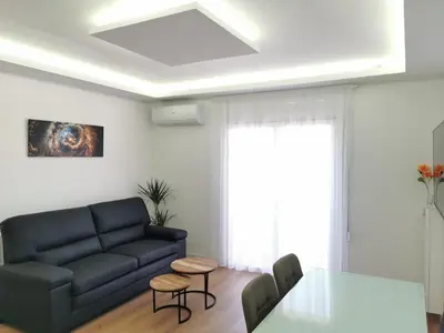 a living room with a blue couch and a table at Ático in Terrassa