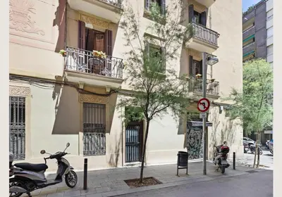a scooter parked on a sidewalk in front of a building at Great apartment in Sagrada Familia with Balcony in Barcelona