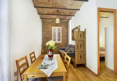 a dining room with a table and a couch at Great apartment in Sagrada Familia with Balcony in Barcelona
