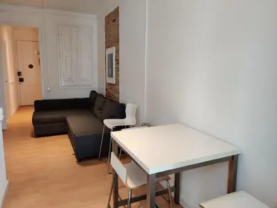 a living room with a couch and a table at Family apartment Gracia in Barcelona