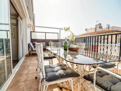 a balcony with a glass table and chairs at Sea and Sand Penthouse by Hello Homes Sitges in Sitges