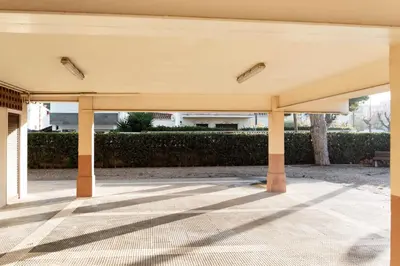 a large pavilion with columns in a courtyard at Refugio playero para 5 personas in Castelldefels