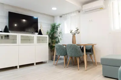 a dining room with a table and a tv at Refugio playero para 5 personas in Castelldefels