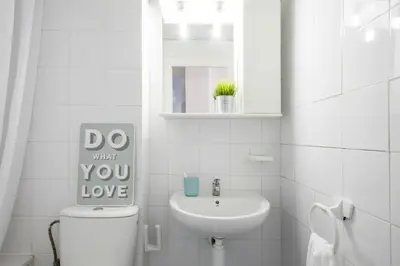 a bathroom with a toilet and a sink and a mirror at Residencia Universitaria Resa Lesseps in Barcelona