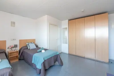 a bedroom with a bed and a cabinet at Residencia Universitaria Resa Lesseps in Barcelona