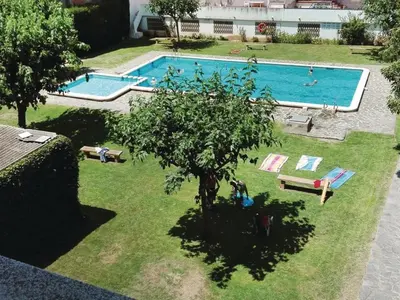 an overhead view of a swimming pool with a tree at Apartamento con vistas al mar y piscina in Pineda de Mar