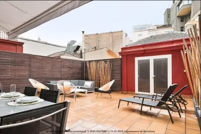 a patio with chairs and tables and a couch at Catalonia Square Terrace & 5 bathrooms 5BD-5BTH in Barcelona