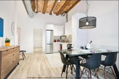 a kitchen and dining room with a table and chairs at Catalonia Square Terrace & 5 bathrooms 5BD-5BTH in Barcelona