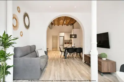 a living room with a couch and a table at Catalonia Square Terrace & 5 bathrooms 5BD-5BTH in Barcelona